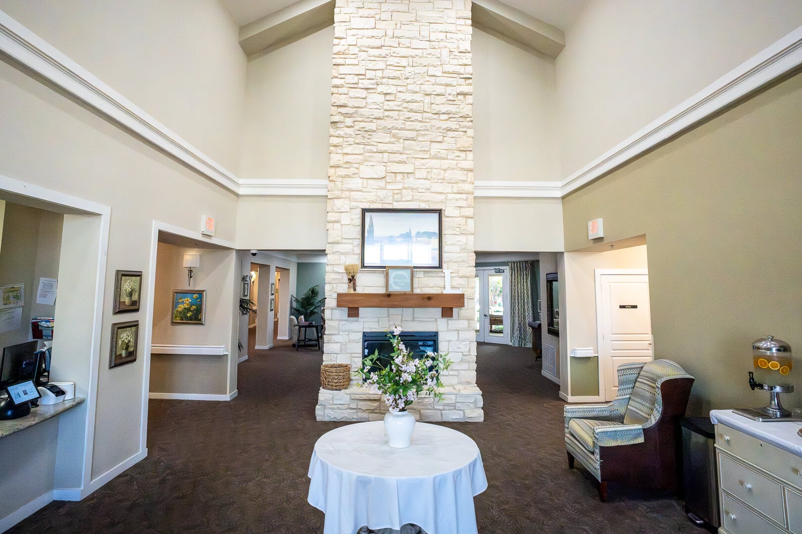 Grand Lobby With Vaulted Ceilings and Central Fireplace for Memory Care Facility