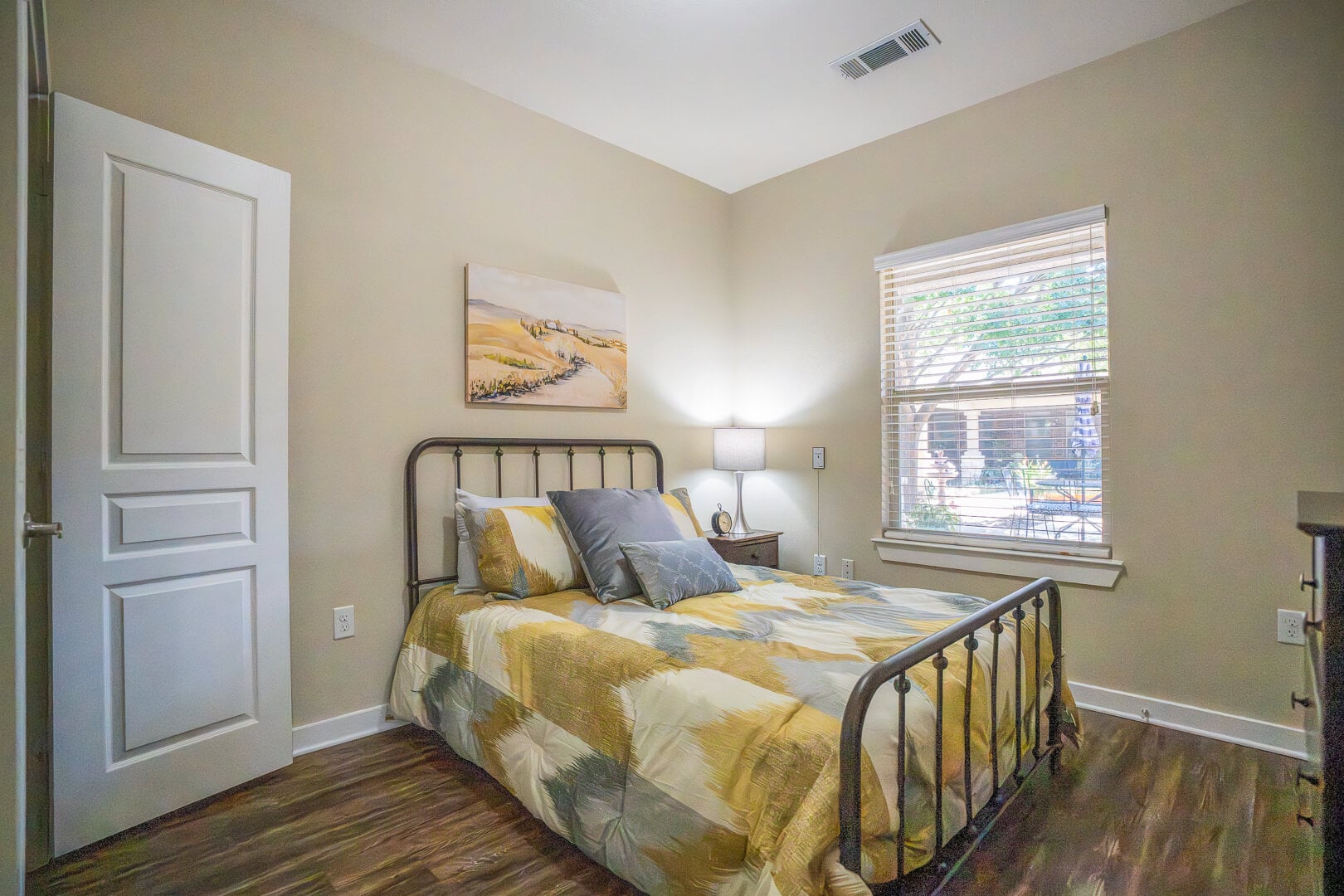 Private Bedroom With Yellow Bedding at Assisted Living Facility
