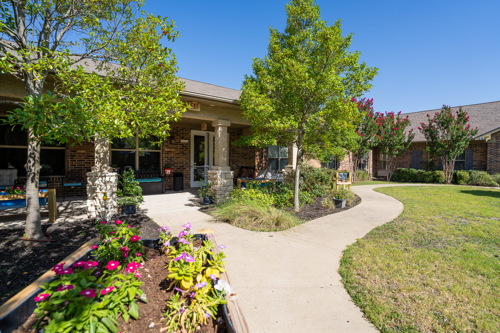 Beautiful Landscaped Campus Walkway at Assisted Living with Memory Care